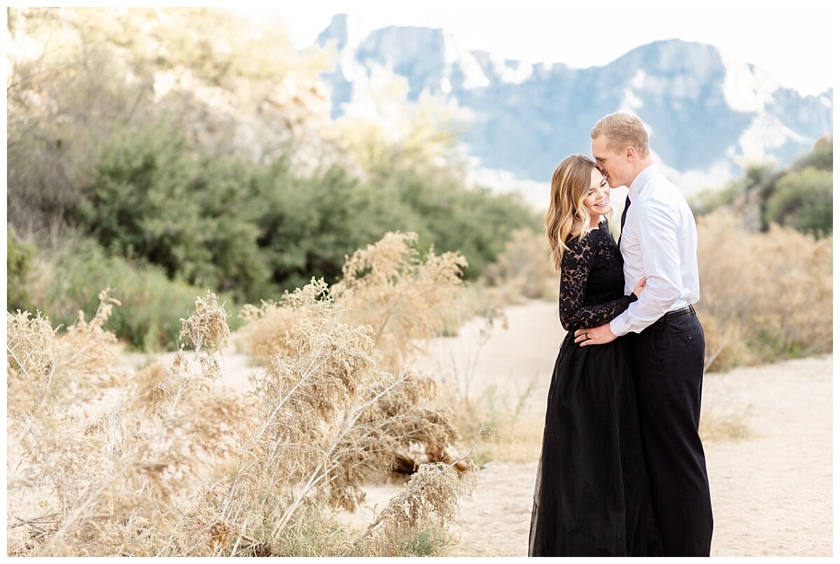 Engagement Session in Arizona desert. Bride-to-be wearing a black tulle skirt and lacey black top at their desert engagement session.