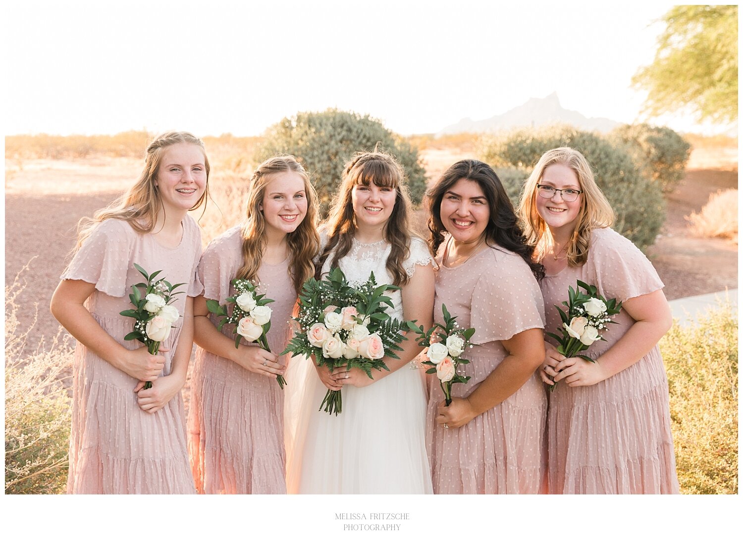Bride and Bridesmaids holding pink rose bouquets. Tucson Wedding photographed by Melissa Fritzsche Photography.