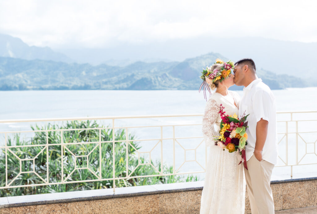 Couple kissing on the balcony of the Hotel Hanalei Bay in Princeville Kauai 