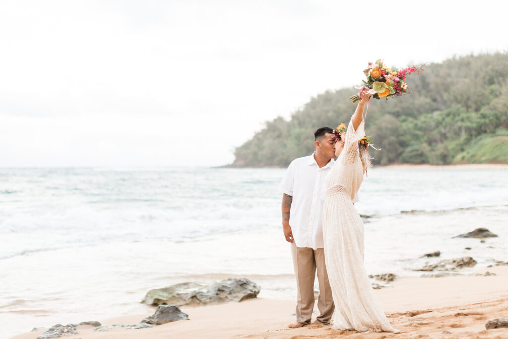 Couple celebrates after their beach wedding in Kauai