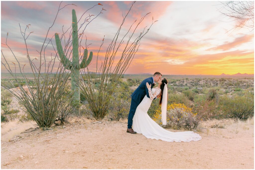 Arizona sunset with red, yellow, and blue sky is the perfect backdrop for this Saugaro Buttes Wedding in Tucson, Arizona.
