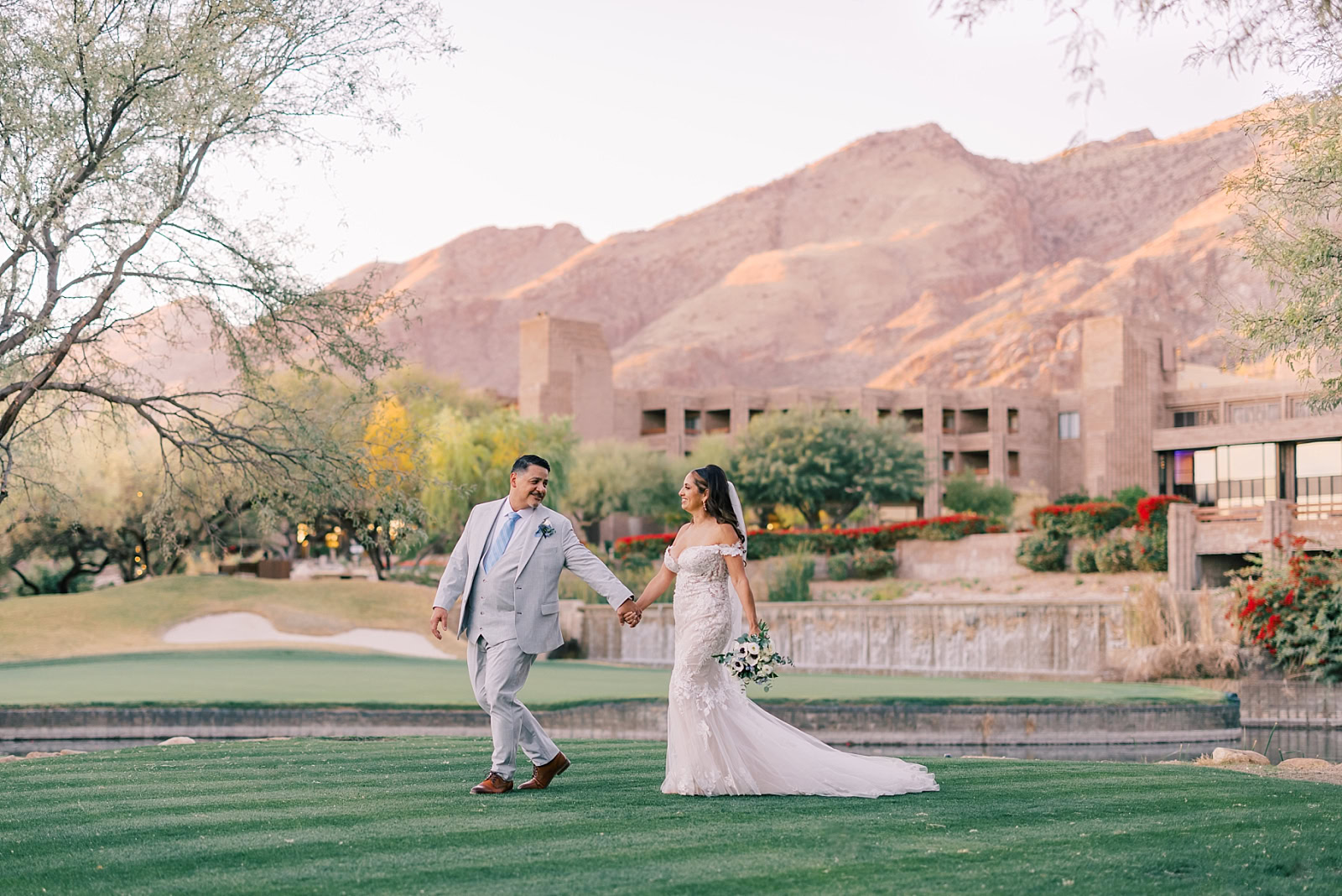 Couple walks hand in hand on their wedding day at Loews Ventana Canyon in Tucson, Arizona